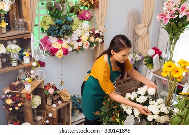 Asian Young Woman Working In Flower Shop