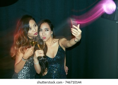 Asian Young Women Taking Selfie In Night Club