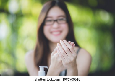 An Asian Young Women Using Alcohol Gel Washing Her Hands To Prevent Corona Virus Covid-19, Hand Sanitizer, Parademic Concept, Selfcare, Disease, Infection, Protection, Covid-19 Safety Guideline.