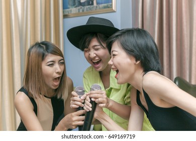 Asian Younger Woman Singing Karaoke Song With Happiness Face