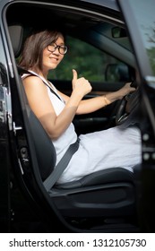 asian younger woman sitting on suv car driving seat toothy smiling face with self confidence