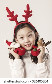 A Asian(japanese, Korean, Chinese) Girl(kid, Children) Portrait With Happy Smile For Christmas(xmas) At The Studio.