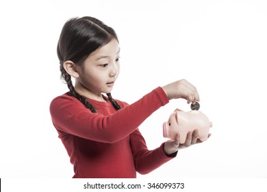 A Asian(korean, Japanese, Chinese) Girl(kid, Student, Child, Woman, Female) Wearing Red Shirts Stand Up With A Pink Pig Coin Bank(money Box) For Banking, Saving, Deposit Isolated White.