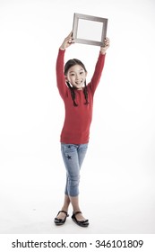 A Asian(korean, Japanese, Chinese) Girl(kid, Student, Child, Woman, Female) Wearing Red Shirts And Denim Pants Stand Up With A Wood Photo Frame For Friend And Family Isolated White.