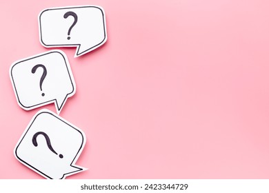 Ask and answer concept. Question marks on speech bubbles, top view.