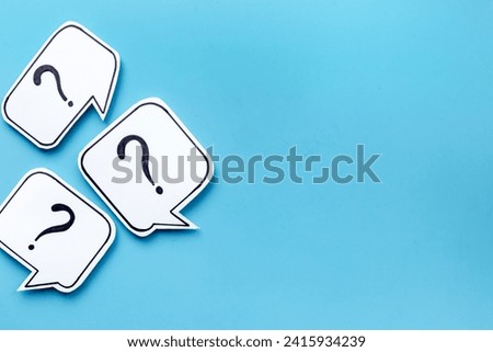 Ask and answer concept. Question marks on speech bubbles, top view.