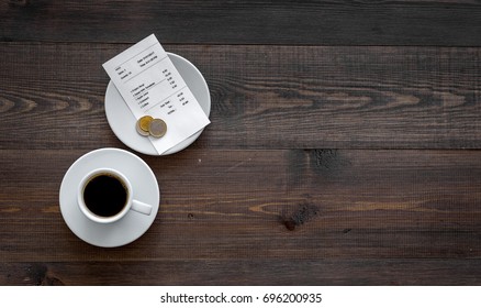 Ask For The Bill At Restaurant. Bill And Coins Near Cup Of Coffee On Wooden Table Top View Copyspace