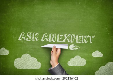 Ask an expert concept on green blackboard with businessman hand holding paper plane