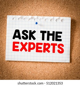 Ask the experts. Sticky note with ask the experts inscription pinned on a cork bulletin board.