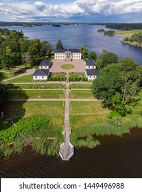 Askersund / Sweden - July 06 2019: Aerial View Of Stjernsund Castle Outside Of Askersund, Närke, Sweden In Summer, With A Person Standing On The Bridge Looking Up At The Castle.