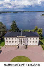 Askersund / Sweden - July 06 2019: Aerial View Of Stjernsund Castle Outside Of Askersund, Närke, Sweden In Summer, With A Person Standing On The Bridge Looking Up At The Castle.