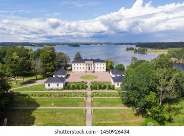 Askersund / Sweden - July 06 2019: Aerial View Of Stjernsund Castle Outside Of Askersund, Närke, Sweden In Summer, With A Person Standing On The Bridge Looking Up At The Castle.