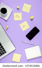 Asking, Decisions. Question mark on sticky notes, notebook, cup coffee, laptop and pen on purple background. FAQ concept. Working with clients. Troubles in work. Flat lay, top view, copy space