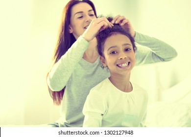 Asking mom for help. Young excited child enjoying down time with her mom. - Powered by Shutterstock