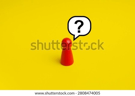 Asking Question concept; Question mark in bubble speech with red peg doll