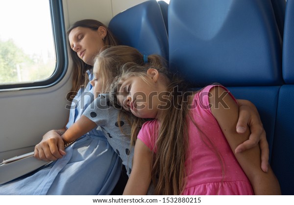 Asleep mom and daughters fell asleep in an electric
train car
