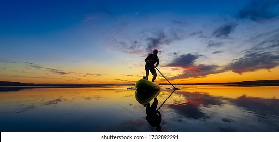 
Aslykul lake. Ufa Republic of Bashkortostan. The Russian Federation. May 2020. SUP surfing. People ride on SUP boards. Aslykul Lake is the best place in the Republic of Bashkortostan for water sports
