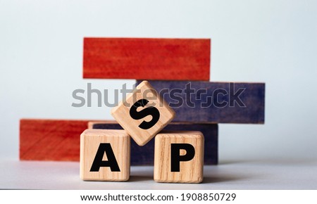 ASP (Application Service Provider) - word on wooden cubes on a background of colored block on a light background. Technology concept