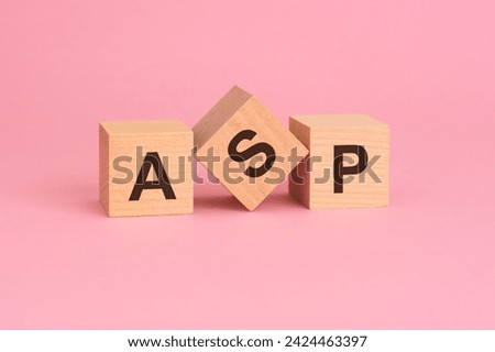 ASP - Average Selling Price symbol. concept word on wooden cubes. beautiful pink background.