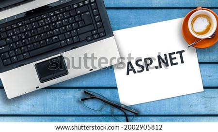 asp.net programming language. Word asp.net on paper and laptop 