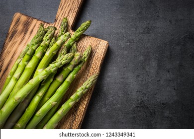 Asparagus. Fresh green asparagus on black slate background. Top view copy space.