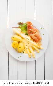 Asparagus And Italian Parma Or Prosciutto Ham With Mayonnaise Served With Baby Boiled Potatoes For A Delicious Cold Summer Meal, Overhead View On White Wooden Table With Copyspace