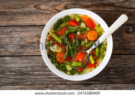 Asparagus soup on wooden table
