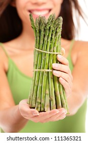 Asparagus. Woman Holding Showing Asparagus In Closeup. Healthy Eating Concept