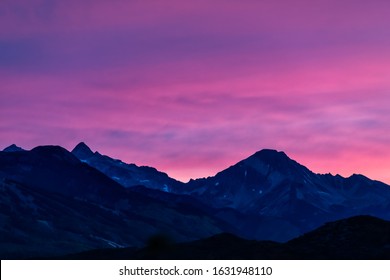 Aspen, Colorado colorful purple pink blue vivid vibrant sunset twilight with Snowmass mountain peak ridge closeup silhouette - Powered by Shutterstock