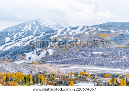 Aspen, Colorado USA small town aerial view with buttermilk ski slope in rocky mountains and small airport runway in roaring fork valley covered in winter snow