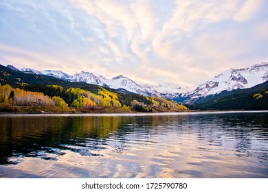 Aspen Trees In The San Juan Mountains Of Colorado With Snow Covered Mountains In Autumn At Sunset