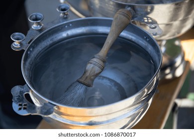 Aspergillum Lies On The Bucket With Holy Water