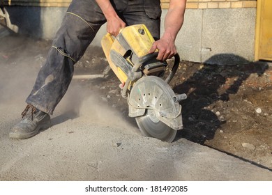 Asphalt or concrete cutting with saw blade at construction site