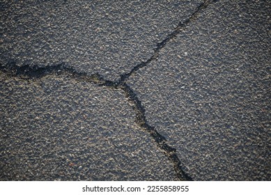 asphalt cracks, pavement destruction, patched asphalt texture of white paint for road marking on asphalt, texture of painted asphalt cracked texture white background, white background on gray wall