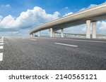 Asphalt highway and bridge under blue sky