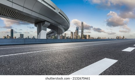 Asphalt highway and city skyline with modern buildings in Shanghai, China.