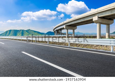 Asphalt highway and green mountains in summer.