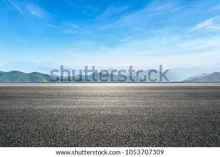 asphalt highway and hill landscape under the blue sky
