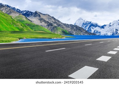 Asphalt highway road and blue lake with mountain nature landscape in summer - Powered by Shutterstock