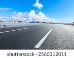 Asphalt highway road and city skyline with sky clouds scenery under blue sky. Outdoor road background.