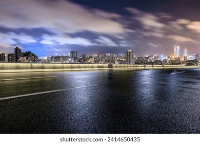 Asphalt highway road and city skyline scenery at night. asphalt road after rain. - Powered by Shutterstock