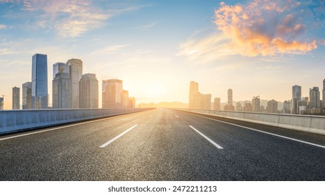 Asphalt highway road and city skyline with modern buildings at sunrise in Chongqing. Panoramic view.