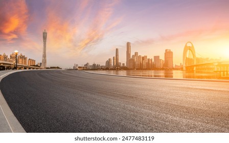 Asphalt highway road and city skyline with modern buildings at sunrise in Guangzhou. Panoramic view. - Powered by Shutterstock