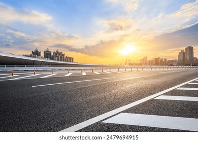 Asphalt highway road and city skyline with modern buildings at sunset. car background. - Powered by Shutterstock