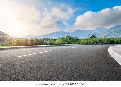 Asphalt highway road and green forest with mountain natural landscape under blue sky - Powered by Shutterstock