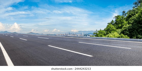 Asphalt highway road and green forest with city skyline in Shenzhen. Panoramic view. - Powered by Shutterstock