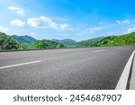 Asphalt highway road and green mountains with sky clouds nature landscape on sunny day