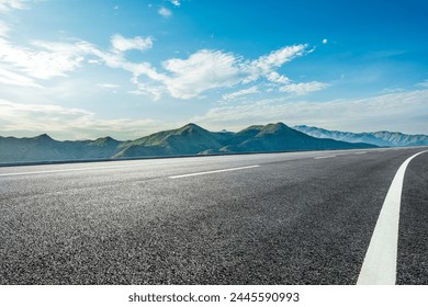 Asphalt highway road and green mountains with sky clouds nature landscape in the morning - Powered by Shutterstock