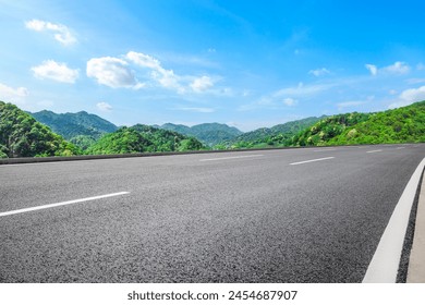 Asphalt highway road and green mountains with sky clouds nature landscape on sunny day - Powered by Shutterstock