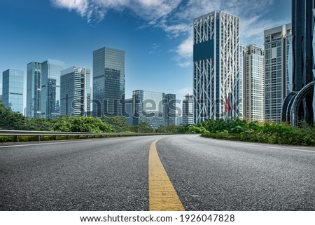 Asphalt highway and urban buildings